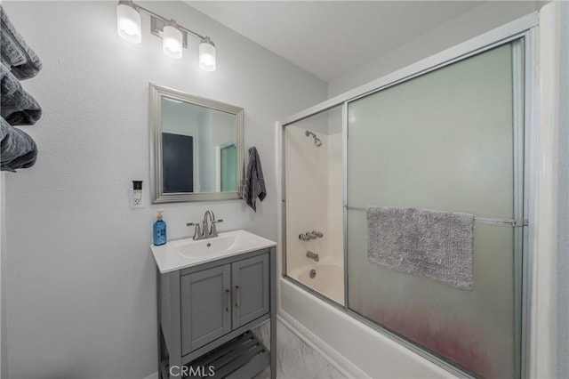 bathroom featuring enclosed tub / shower combo and vanity