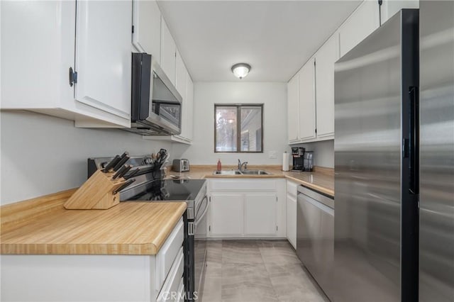 kitchen featuring white cabinets, sink, and stainless steel appliances