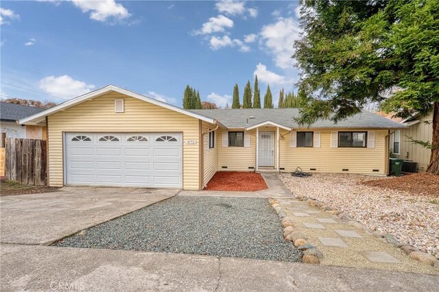 single story home featuring a garage and central AC unit