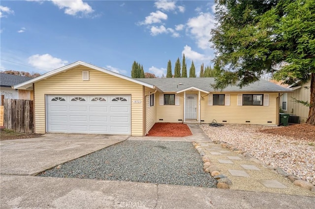 single story home featuring a garage, concrete driveway, crawl space, fence, and central air condition unit