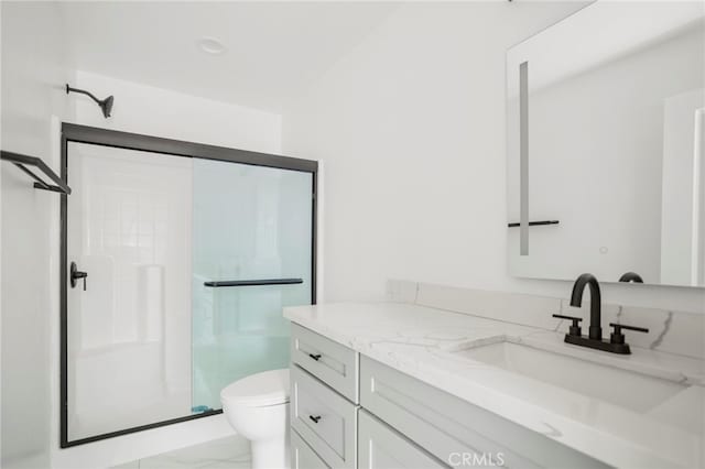 bathroom featuring walk in shower, vanity, and toilet