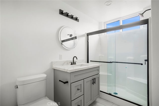 bathroom with vanity, an enclosed shower, and toilet