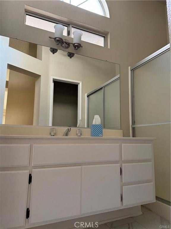 bathroom with a chandelier and vanity