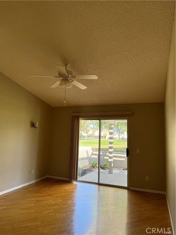 empty room with ceiling fan, a textured ceiling, and light hardwood / wood-style flooring