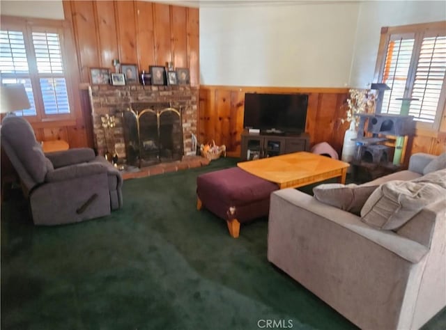 living room featuring a fireplace, carpet, and wood walls