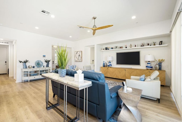 living room featuring ceiling fan and light hardwood / wood-style flooring