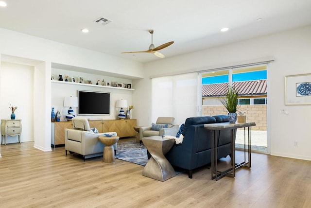 living room with ceiling fan and light wood-type flooring