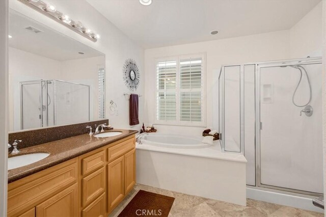 bathroom featuring separate shower and tub and vanity