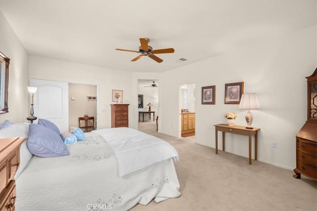 carpeted bedroom with connected bathroom and ceiling fan