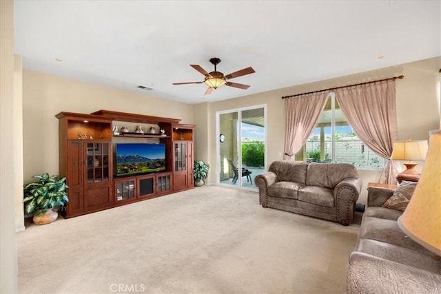 carpeted living room featuring ceiling fan