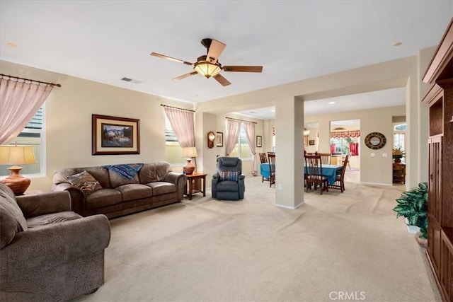 carpeted living room featuring ceiling fan