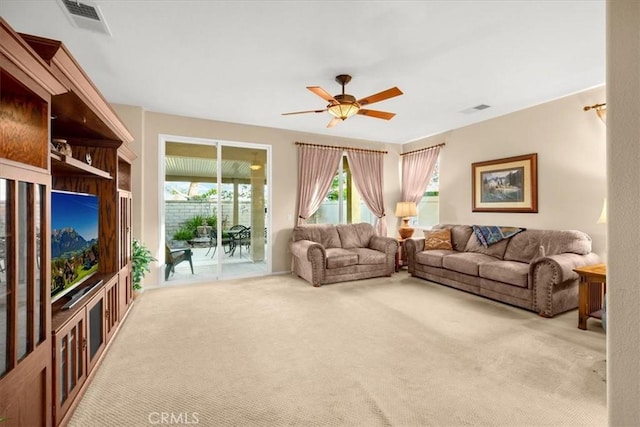 living room featuring carpet flooring and ceiling fan