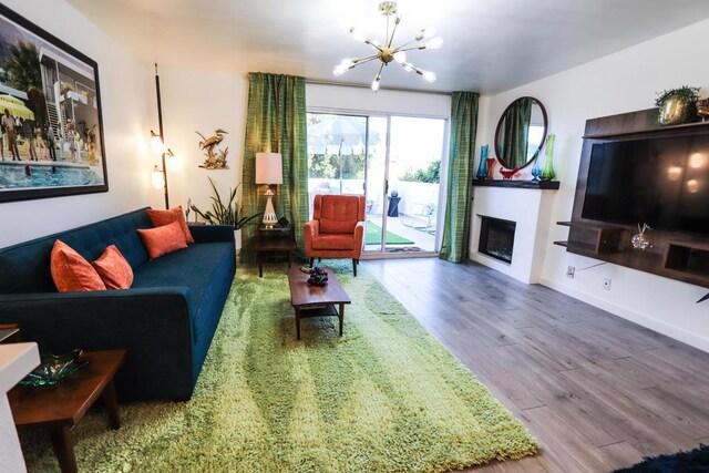 living room with hardwood / wood-style floors and a chandelier