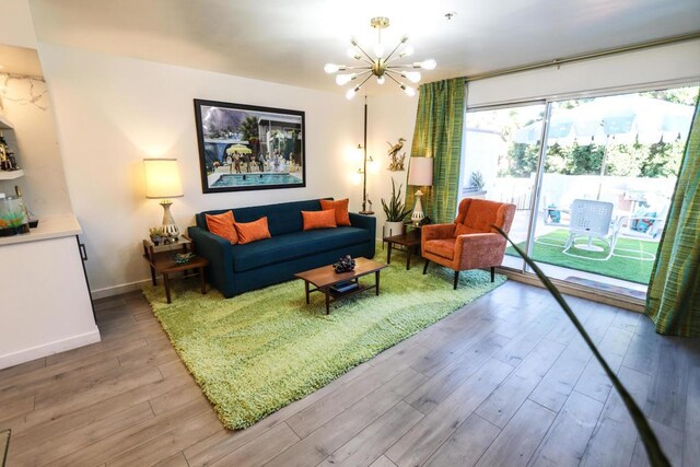 living room with a chandelier and wood-type flooring