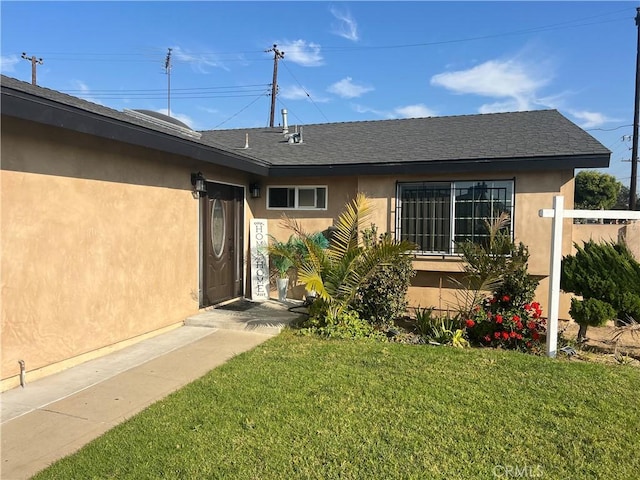 property entrance with a lawn