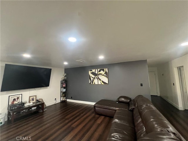 home theater room featuring dark wood-type flooring