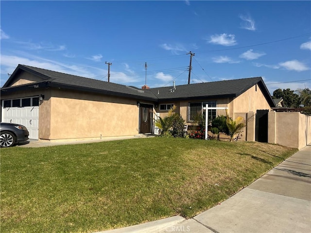 ranch-style house featuring a garage and a front lawn