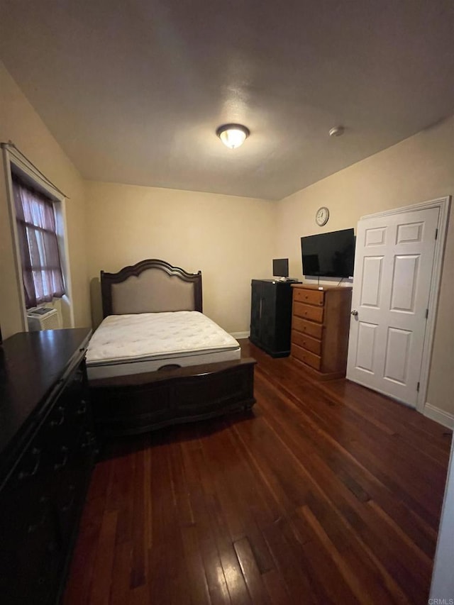 bedroom with dark wood-type flooring