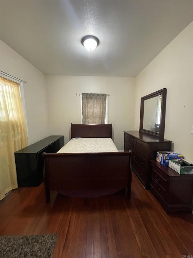 bedroom featuring dark hardwood / wood-style flooring