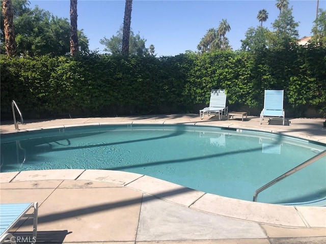 view of swimming pool with a patio