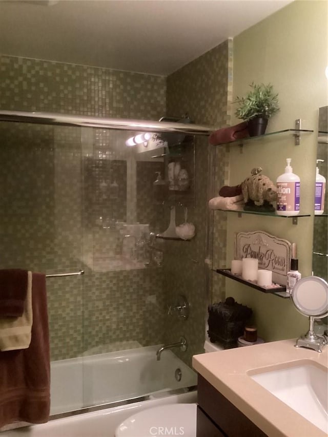 full bathroom with vanity, toilet, and enclosed tub / shower combo