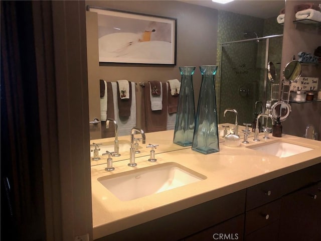 bathroom featuring vanity and a shower with shower door