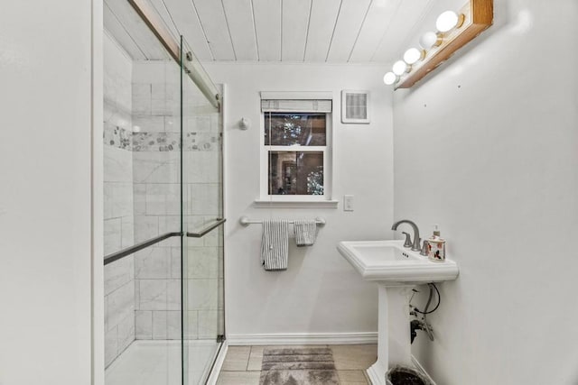 bathroom featuring a shower with shower door