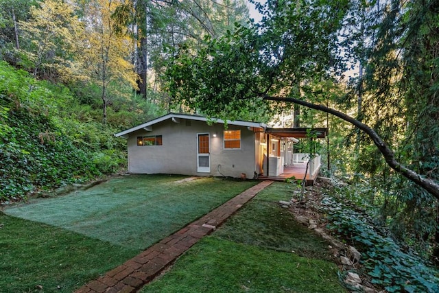 exterior space with a yard and central AC unit