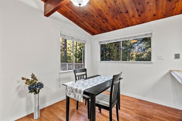 dining space featuring wooden ceiling, lofted ceiling, and light wood-type flooring