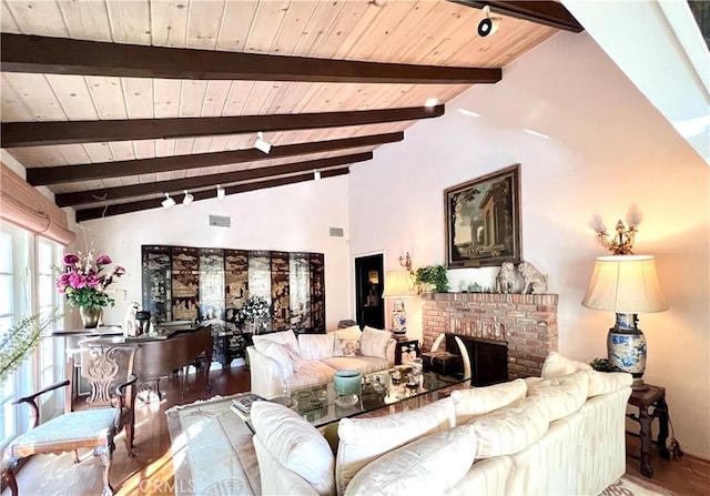living room featuring wood ceiling, wood finished floors, a fireplace, and vaulted ceiling with beams