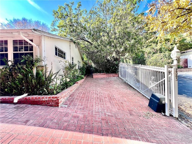 view of patio featuring a gate and fence