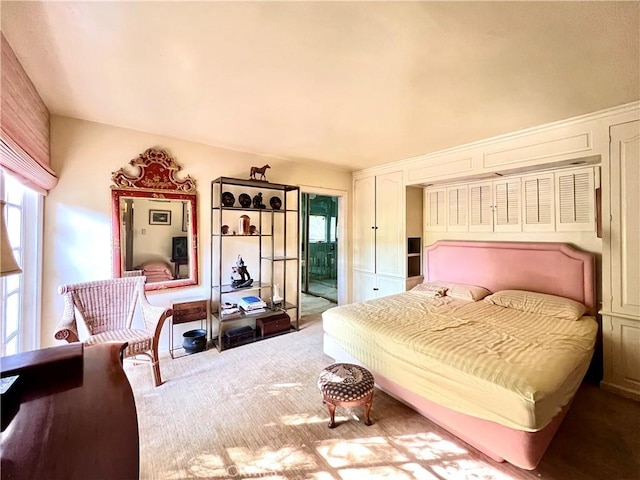 carpeted bedroom with access to outside