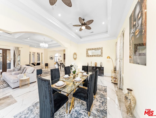 dining space featuring ceiling fan, crown molding, and a tray ceiling