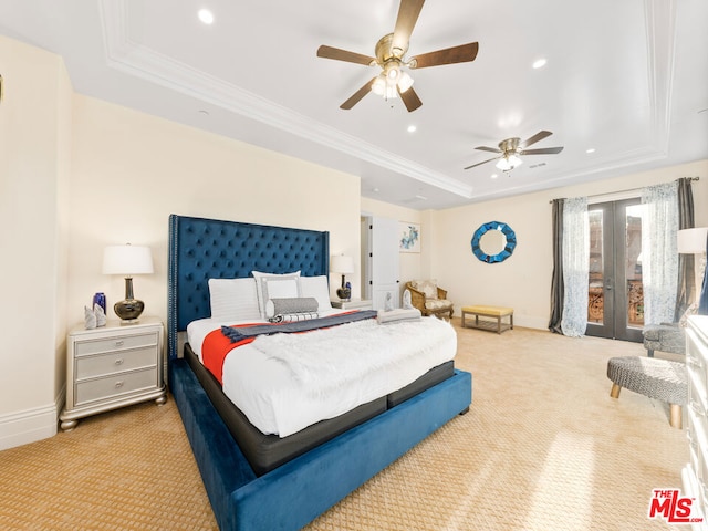 bedroom featuring ceiling fan, light colored carpet, a tray ceiling, and french doors