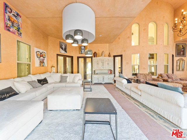 living room with a high ceiling and a notable chandelier