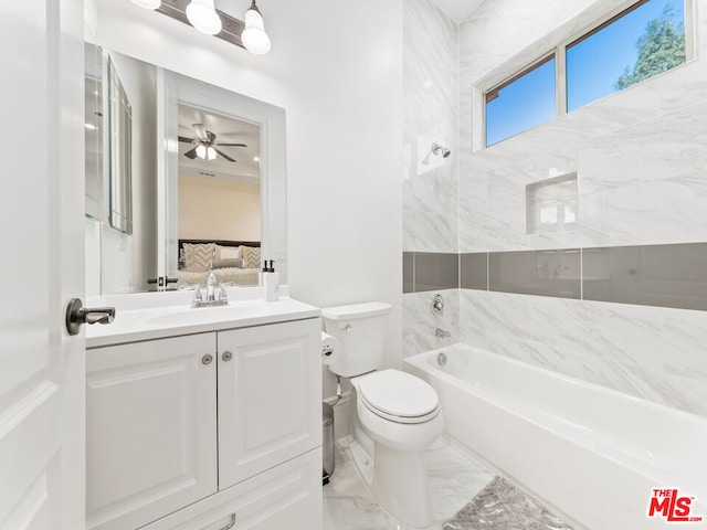 bathroom featuring ceiling fan, toilet, a bath, and vanity