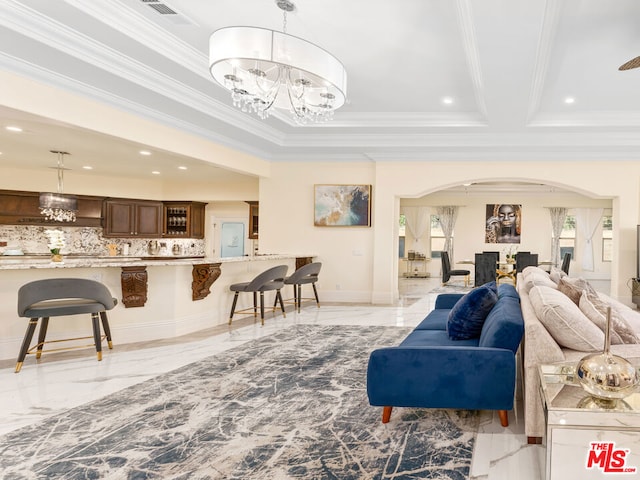 living room featuring ornamental molding and a chandelier