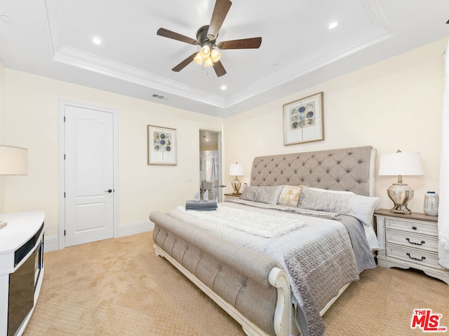 bedroom with ceiling fan, crown molding, light carpet, and a raised ceiling