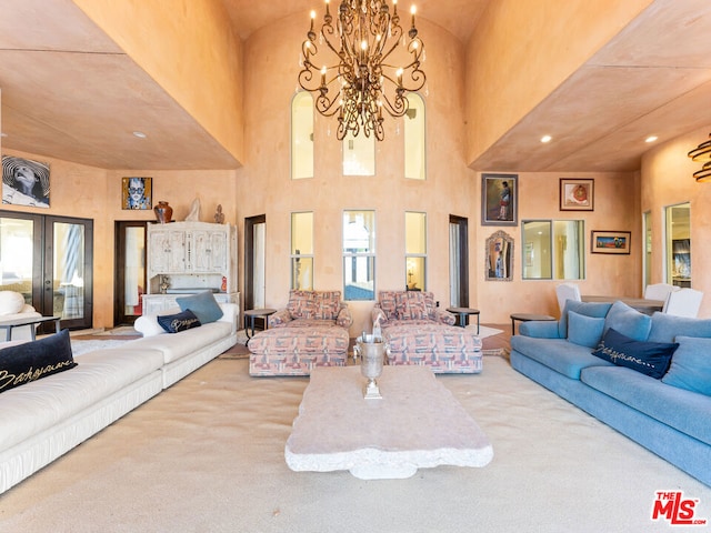 carpeted living room with a high ceiling and a notable chandelier