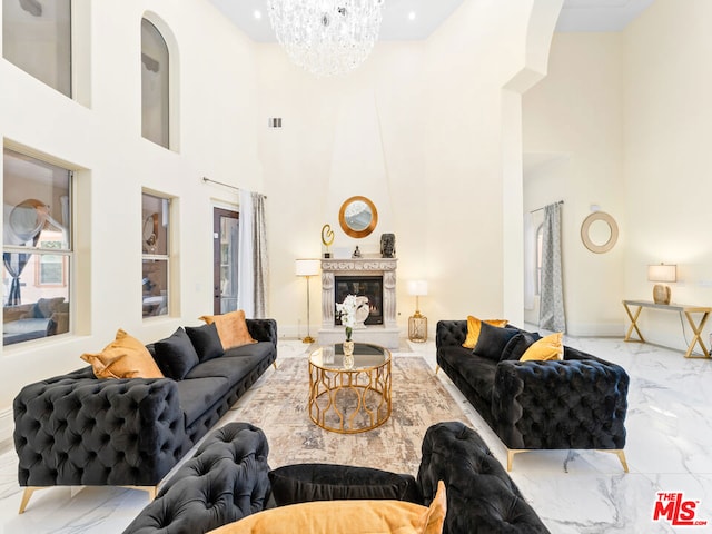 living room featuring a high ceiling and an inviting chandelier