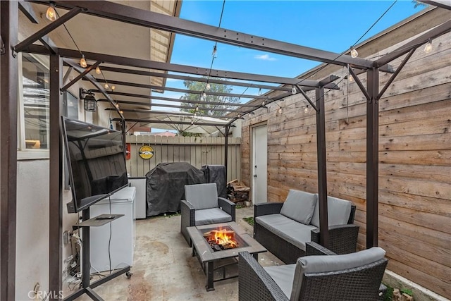 view of patio / terrace featuring area for grilling and an outdoor living space with a fire pit