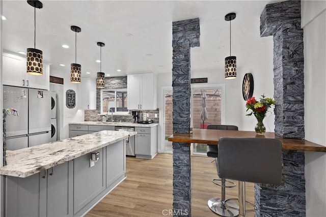 kitchen with white cabinets, light hardwood / wood-style floors, sink, and stainless steel appliances