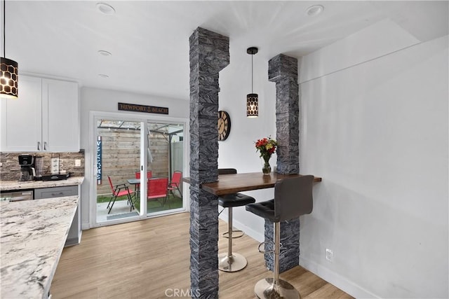 dining space with light hardwood / wood-style floors