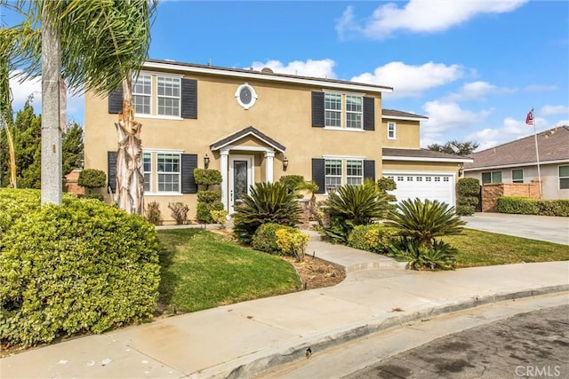 view of front of property featuring a garage and a front lawn