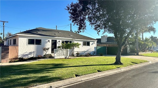 view of front of property with a front yard and fence