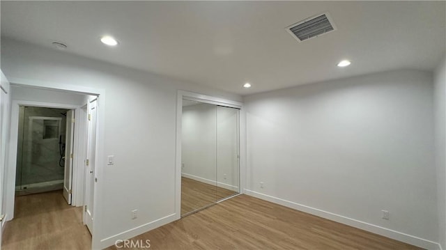 interior space with light wood-style floors, baseboards, visible vents, and recessed lighting