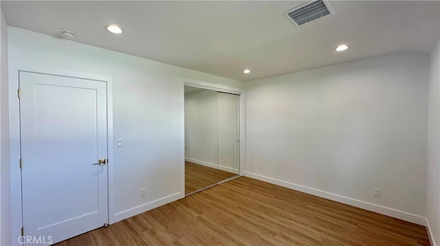 unfurnished bedroom with recessed lighting, baseboards, visible vents, and light wood finished floors