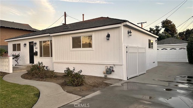 view of front of house with a garage and an outdoor structure