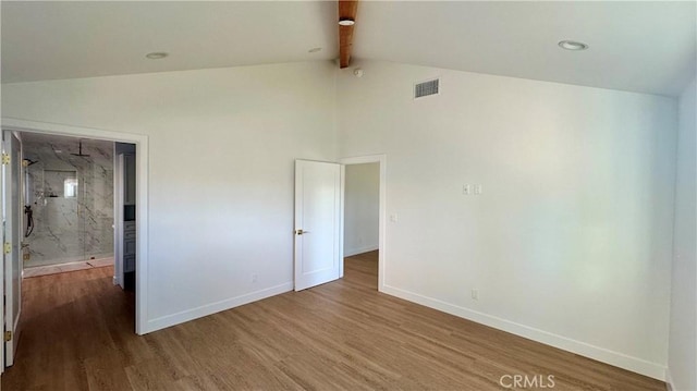 unfurnished bedroom featuring beamed ceiling, wood finished floors, visible vents, and baseboards