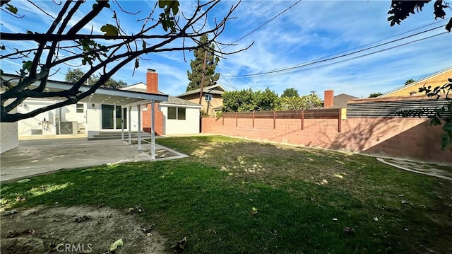 view of yard with entry steps, fence, and a patio